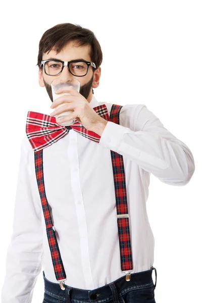 Man wearing suspenders drinking milk. — Stock Photo, Image