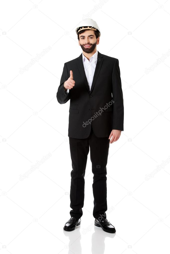 Engineer in protective helmet with thumbs up.