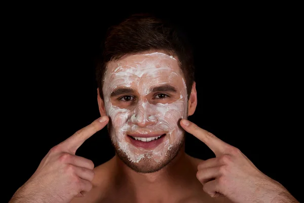 Man with cream moisturizer on his face. — Stock Photo, Image