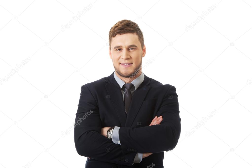 Successful businessman with folded arms.