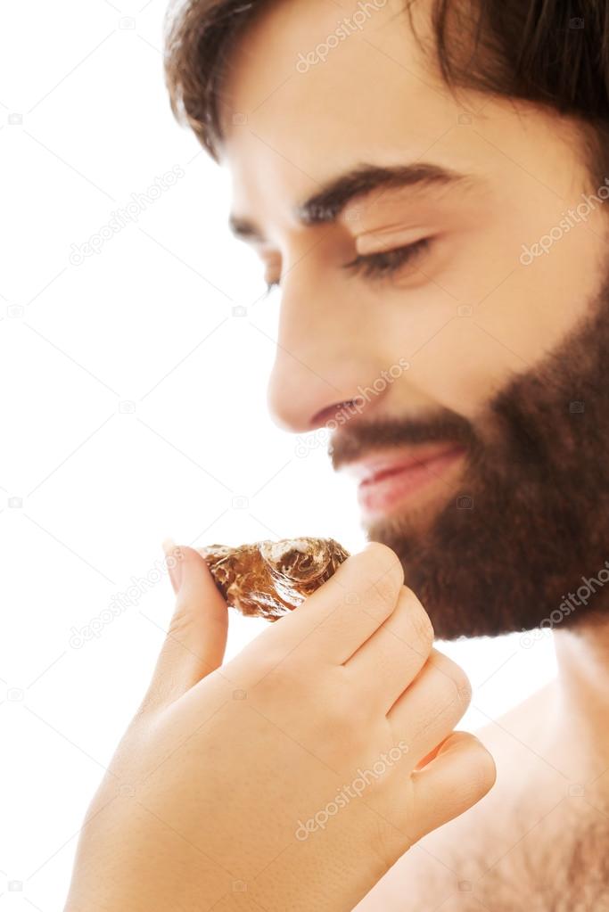 Woman feeds man with oyster.