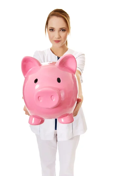 여성 의사는 piggybank 들고. — 스톡 사진