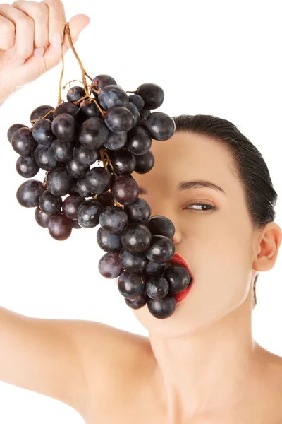 Woman eating grapes — Stock Photo, Image