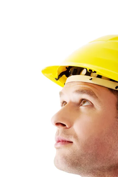 Man in hardhat looking up — Stok Foto