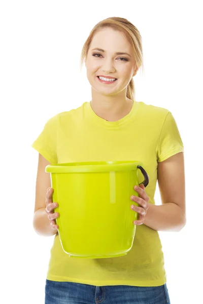 Woman holding yellow bucket. — Stock Photo, Image
