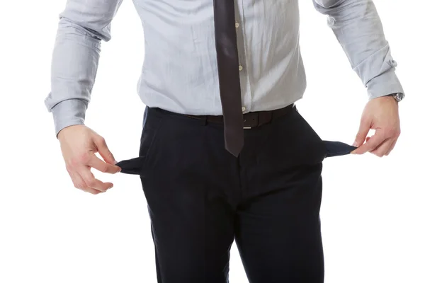 Affärsman visar sina tomma fickor. — Stockfoto
