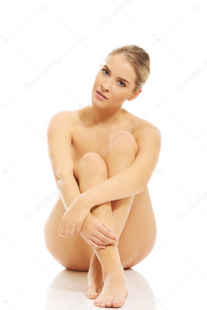 Nude woman sitting on the floor
