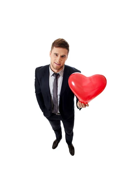 Бізнесмен з кулькою у формі серця . — стокове фото