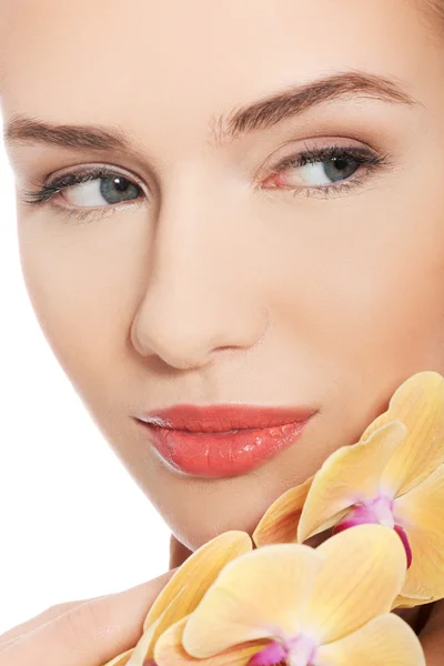 Nude woman with an orchid flower — Stock Photo, Image