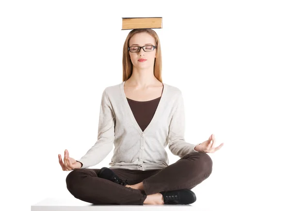 Woman with book on head. — Stock Photo, Image
