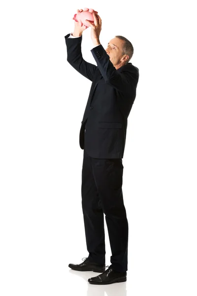 Happy businessman holding piggybank — Stock Photo, Image