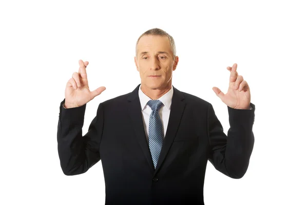 Businessman with fingers crossed — Stock Photo, Image