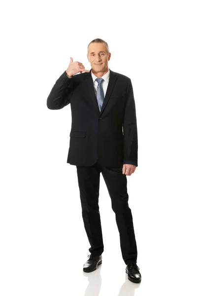 Businessman with call me gesture — Stock Photo, Image