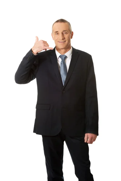 Businessman with call me gesture — Stock Photo, Image