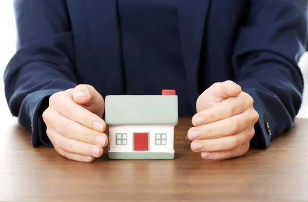 Businesswoman presenting a model house Stock Photo