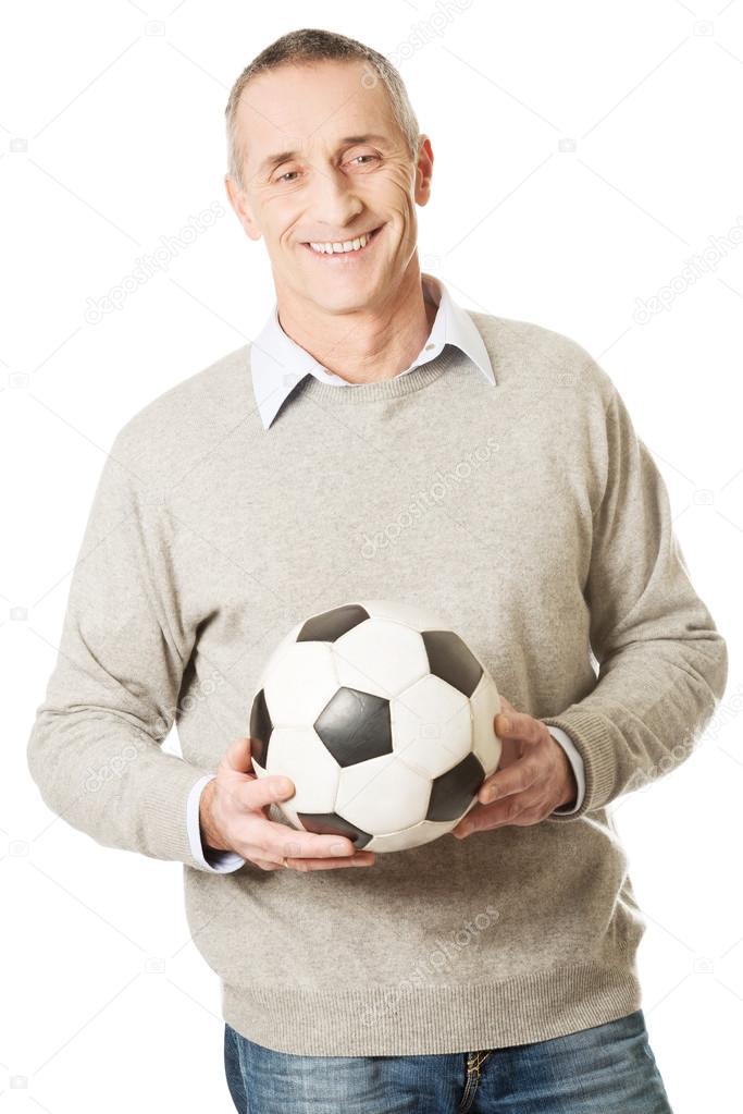 Mature man with a soccer ball