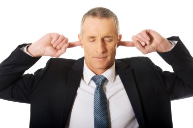 Businessman plugging his ears clipart