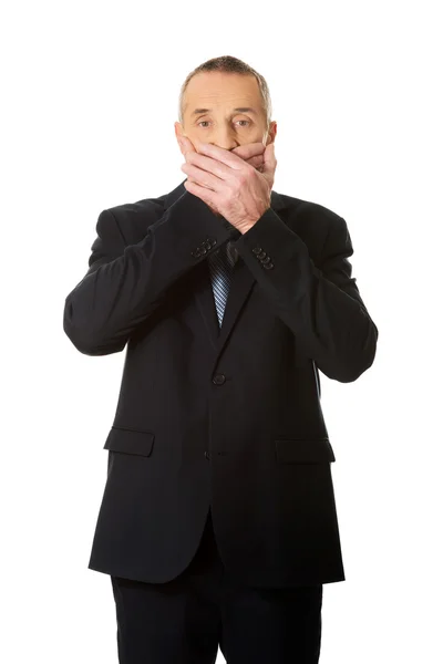 Uomo d'affari che si copre la bocca — Foto Stock