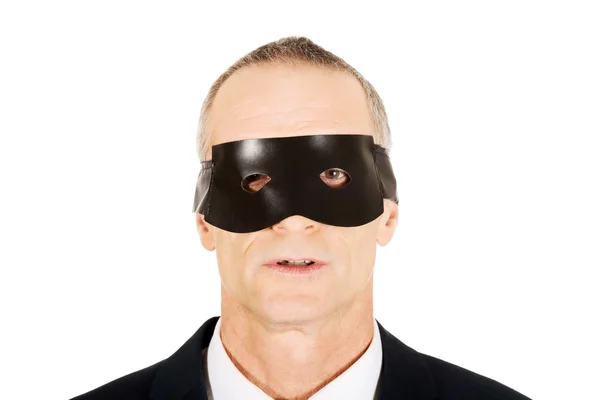 Businessman wearing black eye mask — Stock Photo, Image