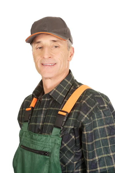 Mature gardener standing in uniform — Stock Photo, Image