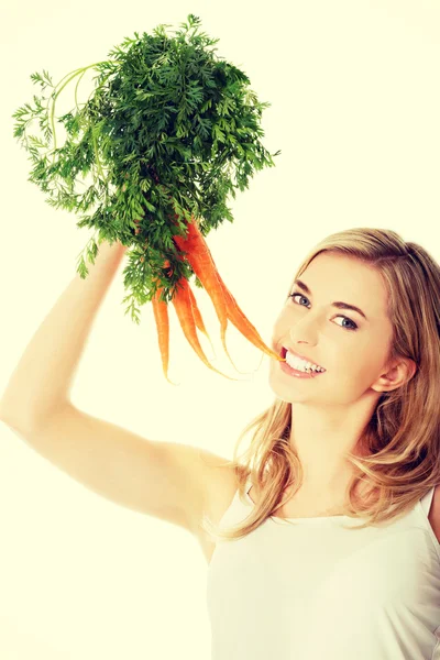 Young woman with the carrots — Stock Photo, Image