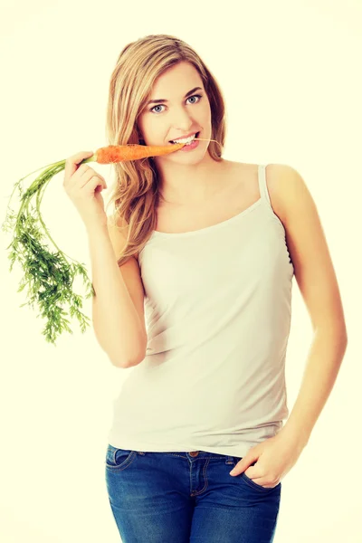 Young woman with the carrots — Stock Photo, Image