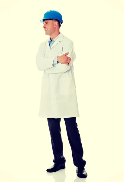 Man in a lab coat and helmet — Stock Photo, Image