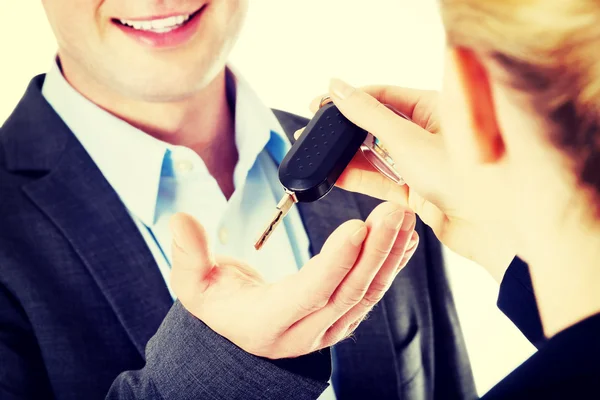 Car salesman handing over the keys — Stock Photo, Image