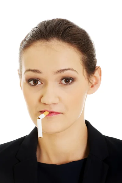 Businesswoman with broken cigarette in mouth. — Stock Photo, Image