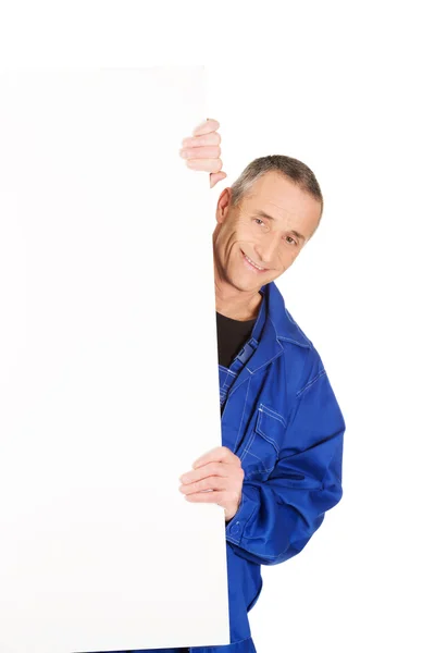 Happy worker presenting empty banner — Stock Photo, Image