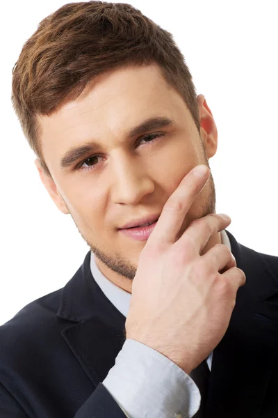 Businessman with fingers under chin. — Stock Photo, Image