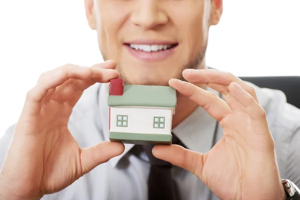 Businessman with house model — Stock Photo, Image