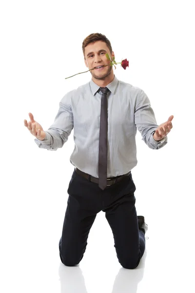 Man holding red rose in his mouth. — Stock Photo, Image