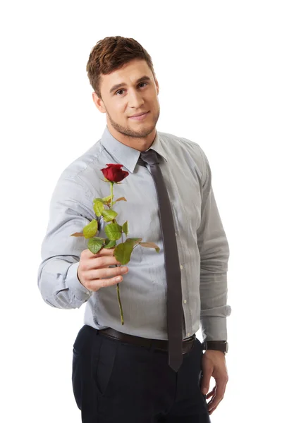 Handsome man holding red rose. — Stock Photo, Image