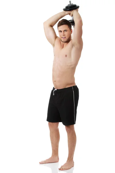 Homem musculoso exercitando com pesos .. — Fotografia de Stock