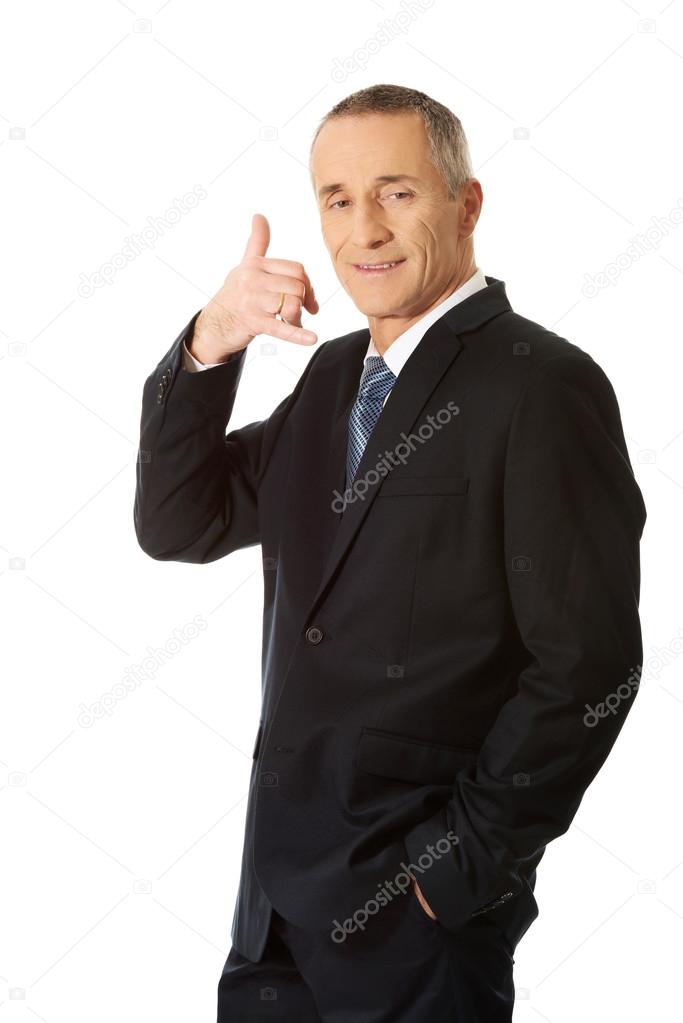 Businessman with call me gesture