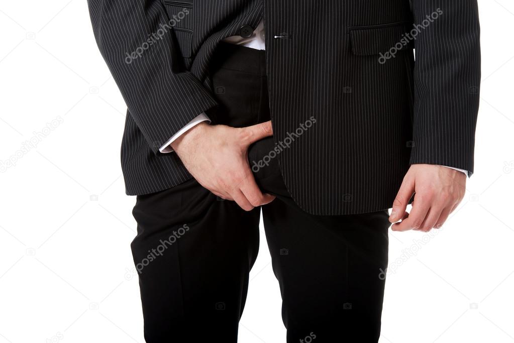 Businessman feeling pain in his crotch.