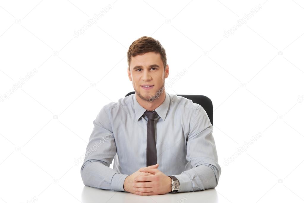 Businessman sitting by a desk in the office.