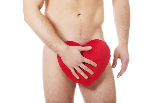 Nude man covering his self with heart. — Stock Photo, Image