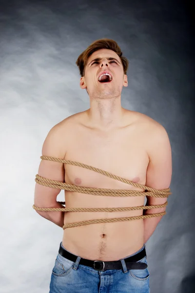 Tortured man tied with a rope. — Stock Photo, Image