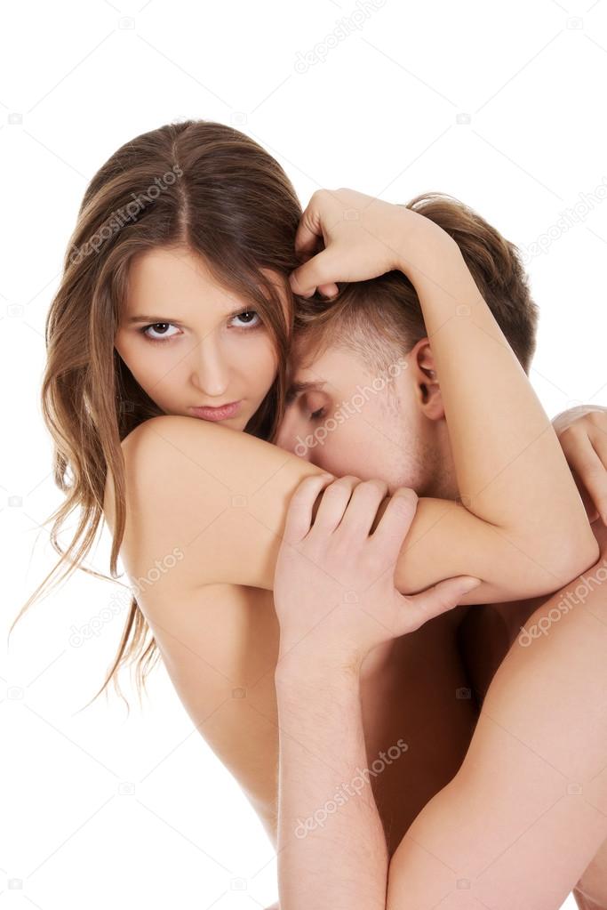 Naked couple in a tender embrace.