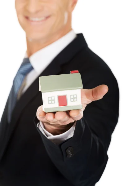 Businessman holding house model — Stock Photo, Image