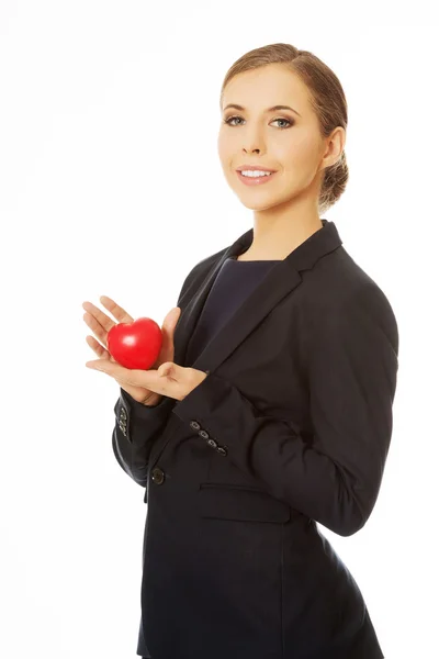 Businesswoman holding heart — Stock Photo, Image