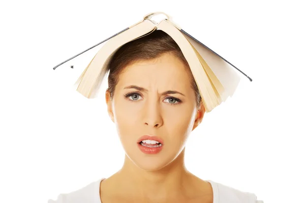 Woman holding book on head — Stock Photo, Image