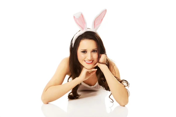 Woman in bunny ears lying on floor — Stock Photo, Image