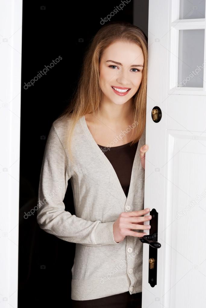 Woman opening her house door