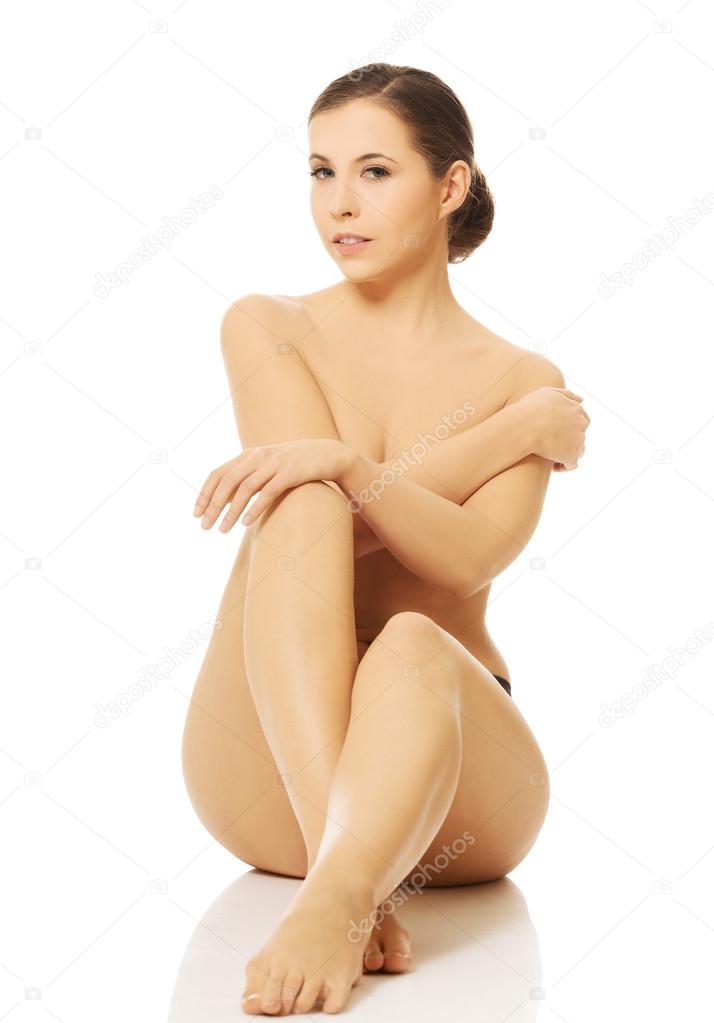 Nude woman sitting on the floor