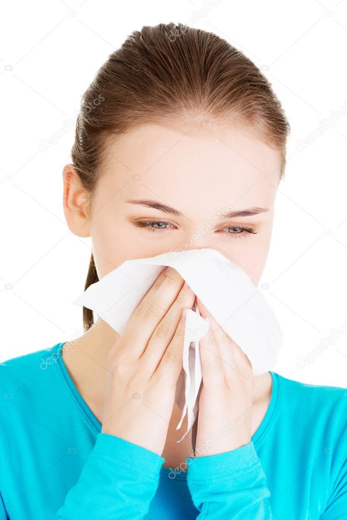 Blonde woman sneezing