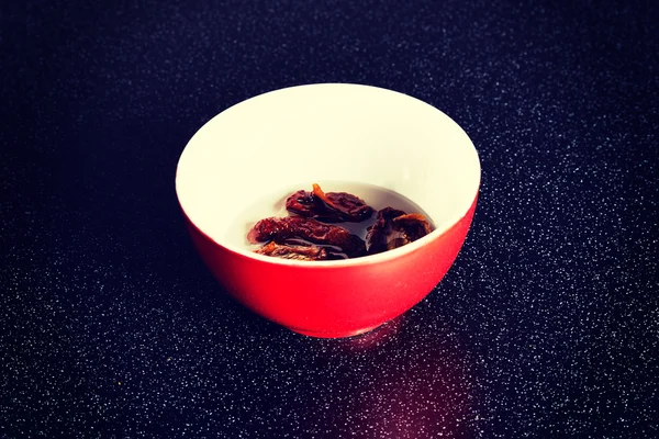 Red bowl with dry tomatoes — Stock Photo, Image