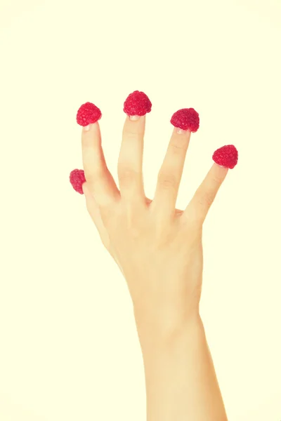 Fingers with red raspberries. — Stock Photo, Image